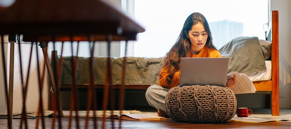 Female student on computer taking online medical school classes