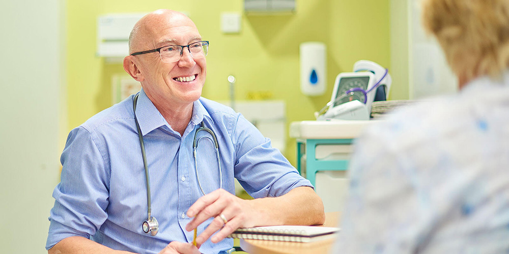 A family physician speaks with a family after a routine visit