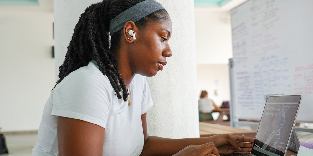 SGU Student studying on laptop