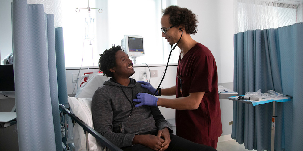 Student examining patient