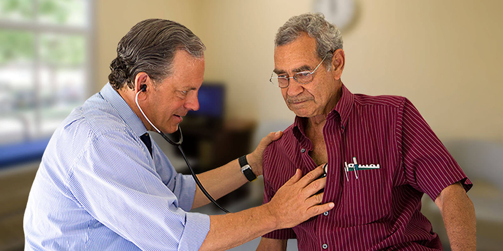 Doctor listening to patient's heart