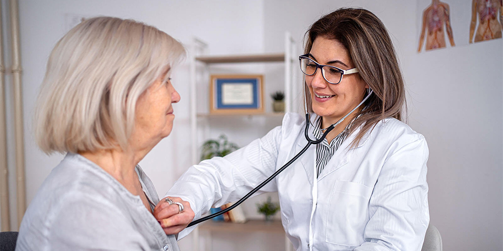 Physician checking patient's heartbeat.