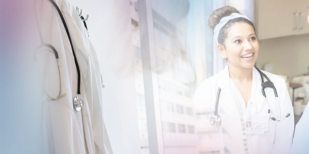 Group of medical residents talking in hospital hallway