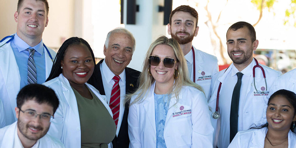 SGU students have their picture taken with the Chancellor