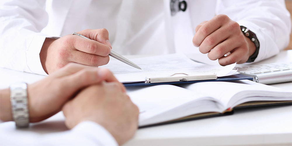 Close up of doctor reviewing application materials