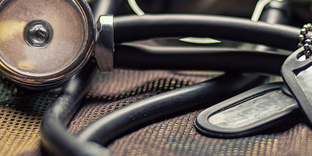 Extreme close-up shot of military tags and a stethoscope