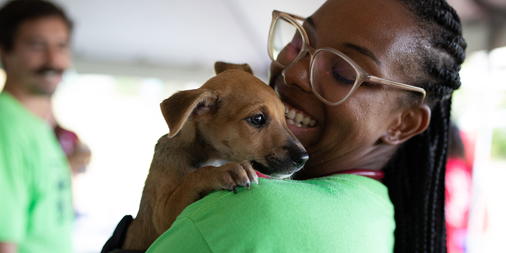 Student holding puppy