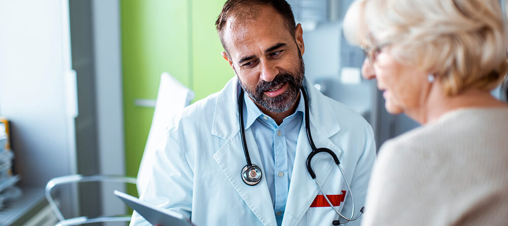 A doctor engages in conversation with a patient, discussing health concerns in a friendly and supportive manner.