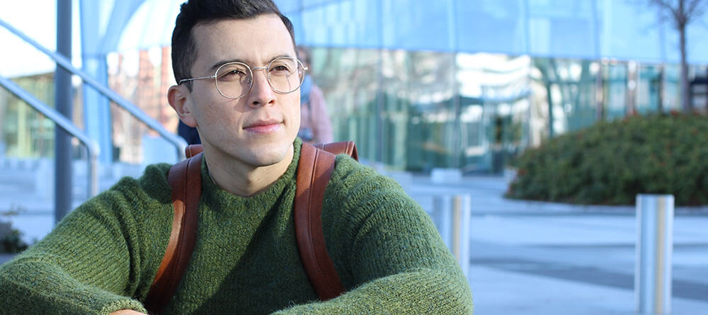 Male student sitting outside contemplating his future
