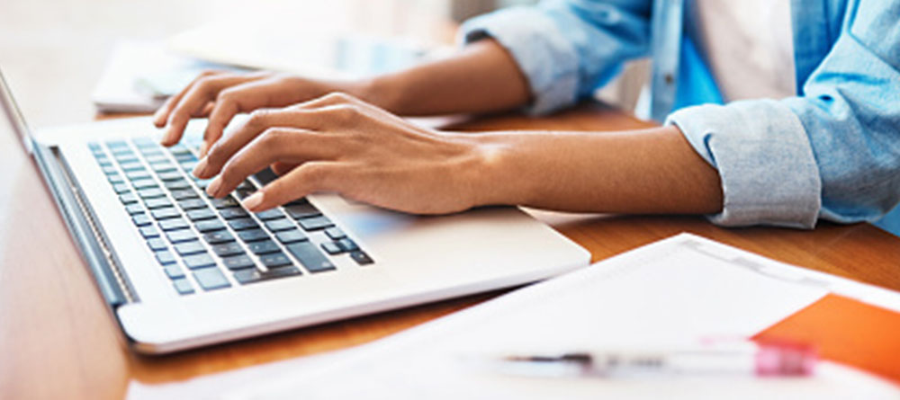 Student studying on laptop for MCAT exam