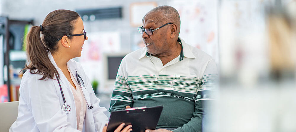 Primary care physician educating patient.