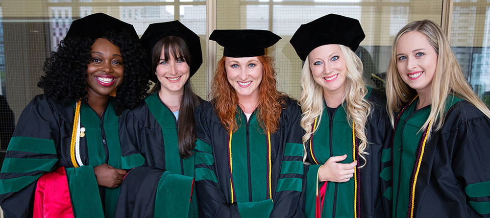 A group of SGU medical school graduates smile for a photo