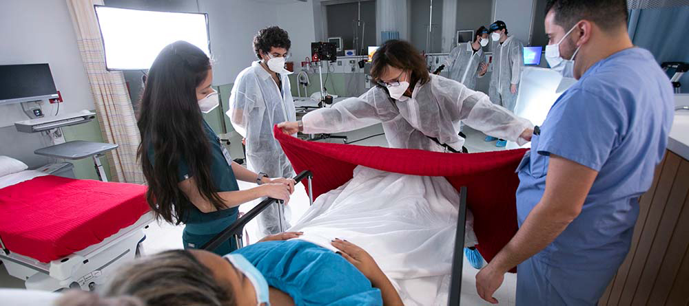 Group of SGU students observing patient in exam room
