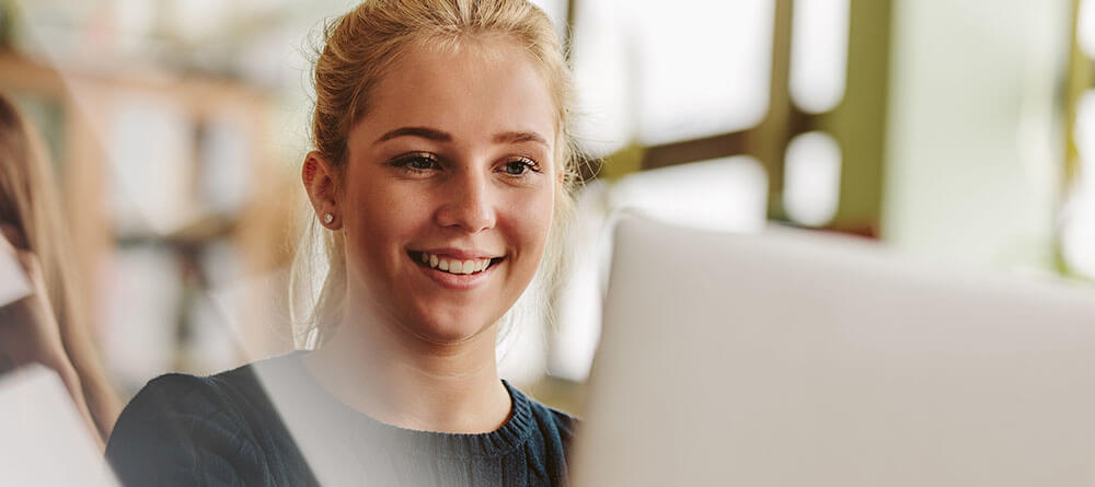 Pre med student submitting fafsa for medical school on laptop