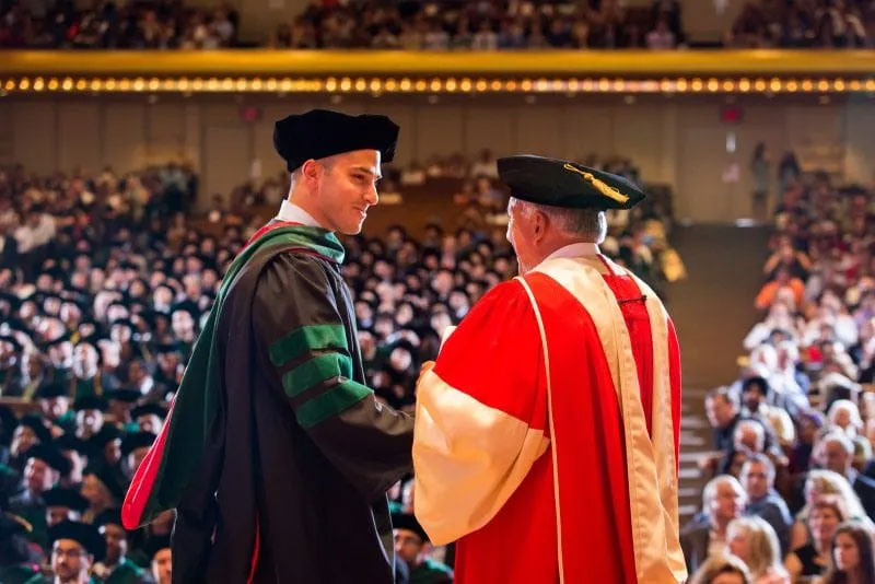 SGU Graduate receiving diploma