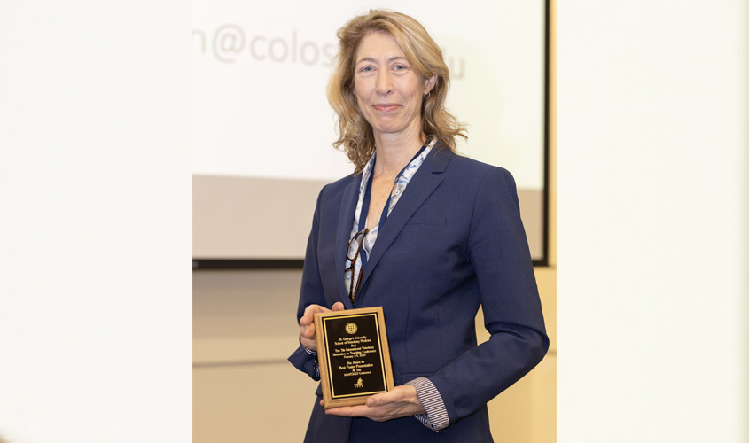 Dr. Carolyn Kerr, a professor at the University of Guelph, Ontario Veterinary College, accepts her award for Best Poster Presentation.