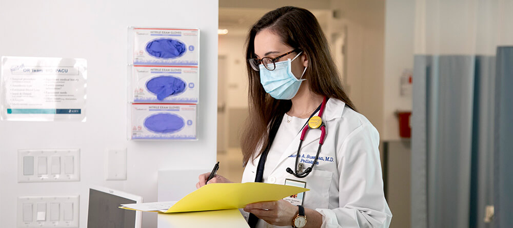 Doctor filling out patient chart