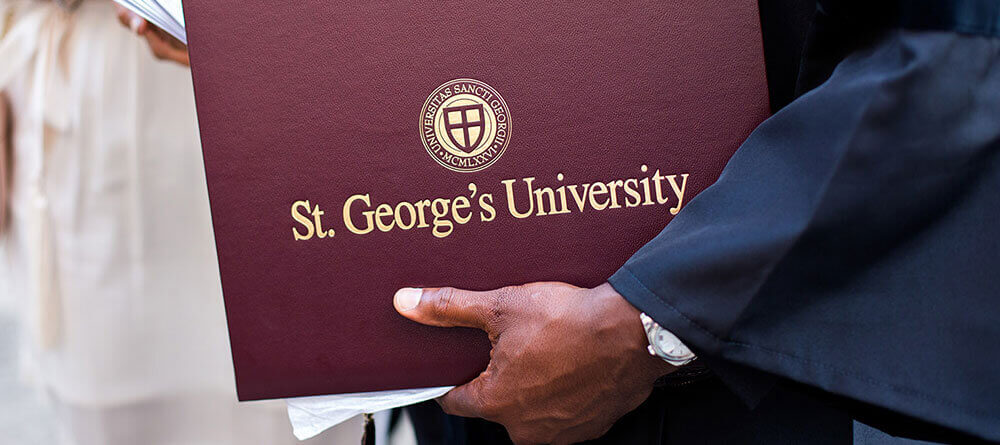 SGU graduate holding degree