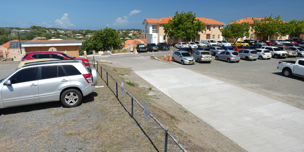 Student parking lot, new concrete driveway now connects the main road to the lot