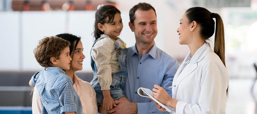  A family physician speaks with a family after a routine visit.