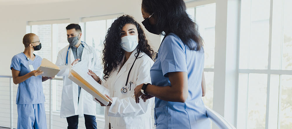 A medical student discusses charts with a doctor