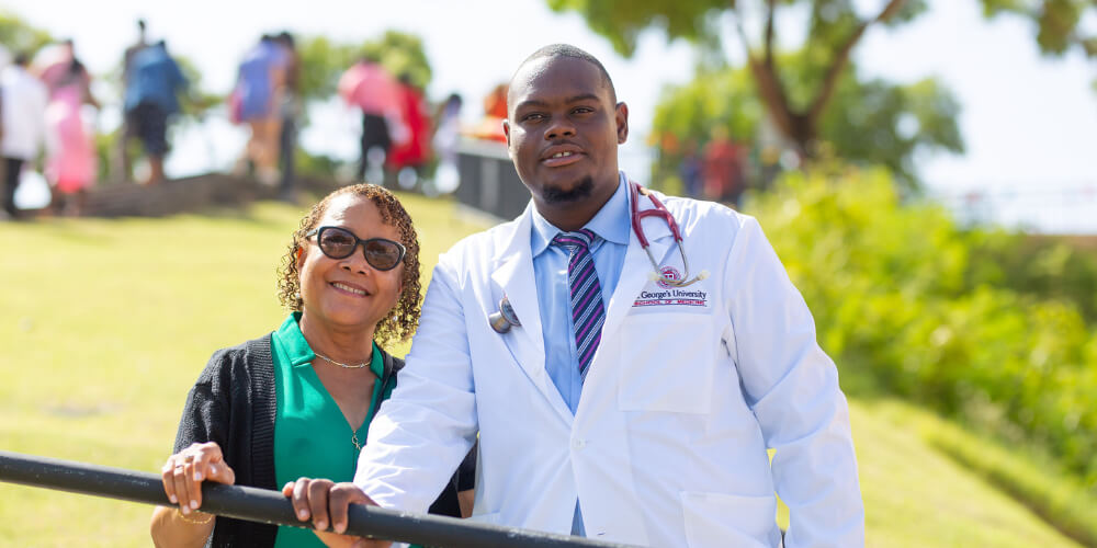 Jamal Courtney, BSN ’23, coated by his mentor, Beverly Nelson, MD ’86