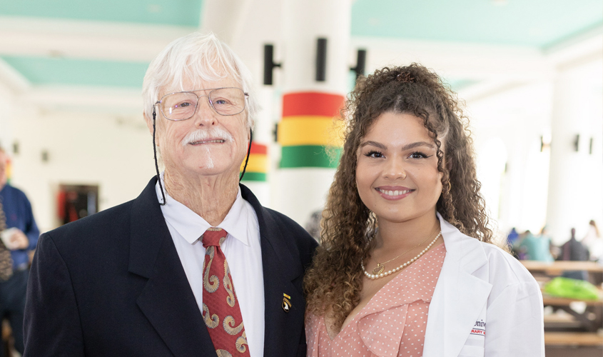 Unable to hold back tears, Dr. Ron Ridge, hospital director at St. Francis Emergency Hospital in Fort Lauderdale, FL, was proud of his daughter, Amy Ridge, SVM Term 1 student. Having practically raised Amy in a veterinary hospital during his 40-year tenure as a veterinarian, Dr. Ridge felt honored to coat his daughter at this once-in-a-lifetime experience.
