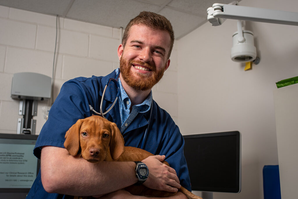 SVM Student Holding Puppy