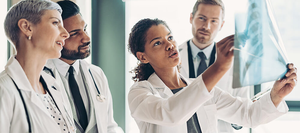 Team of doctors examining an X-ray