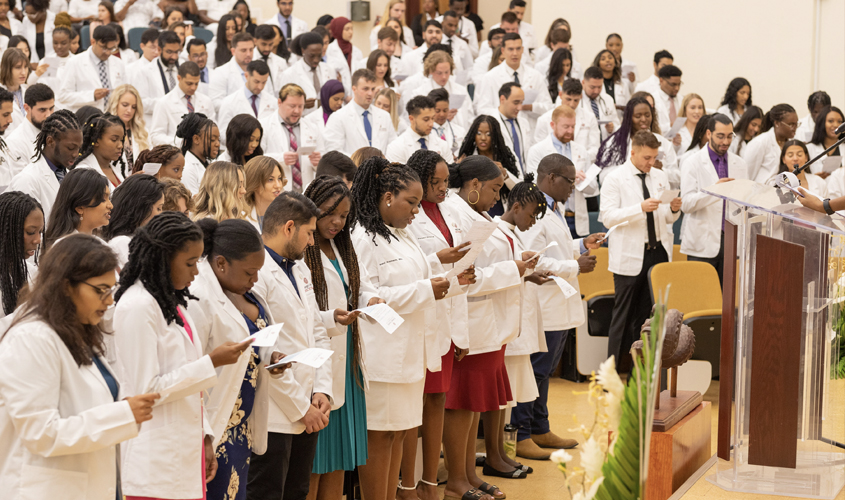 After receiving their white coats, the ceremony ended with students and other physicians in the audience reciting the Oath of Professionalism—pledging to uphold the highest of ethical standards while treating their patients. 