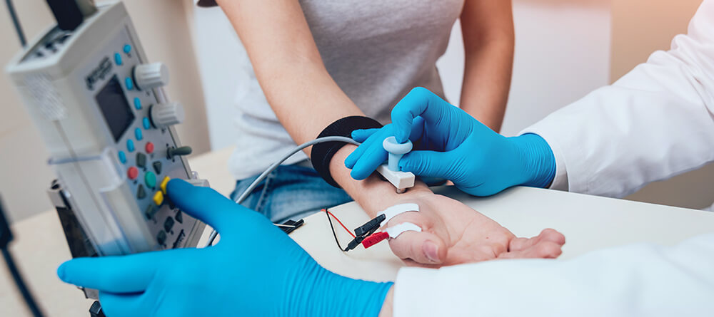 Close up of neurologist performing an electromyography test on patient