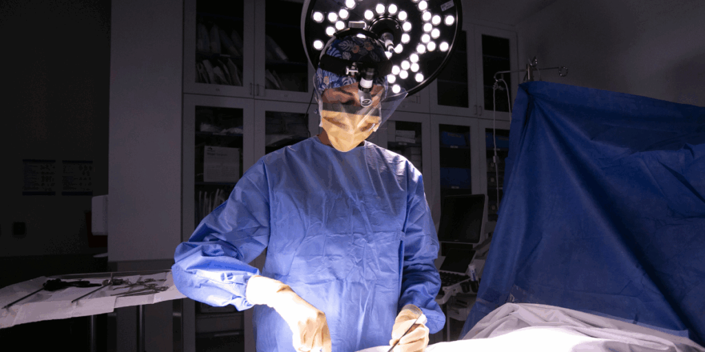 woman in scrubs prepares to operate