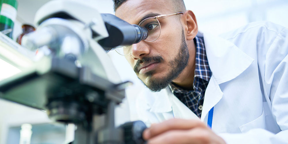 Physician using microscope