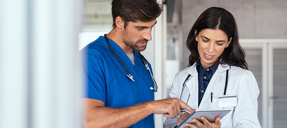 MD and NP discussing a patient’s medical chart