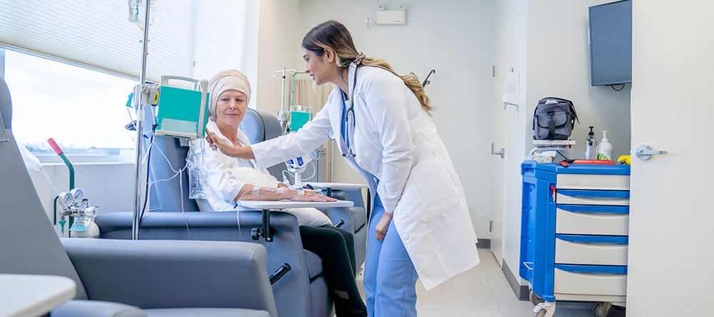 Physician facilitating treatment for cancer patient in an exam room