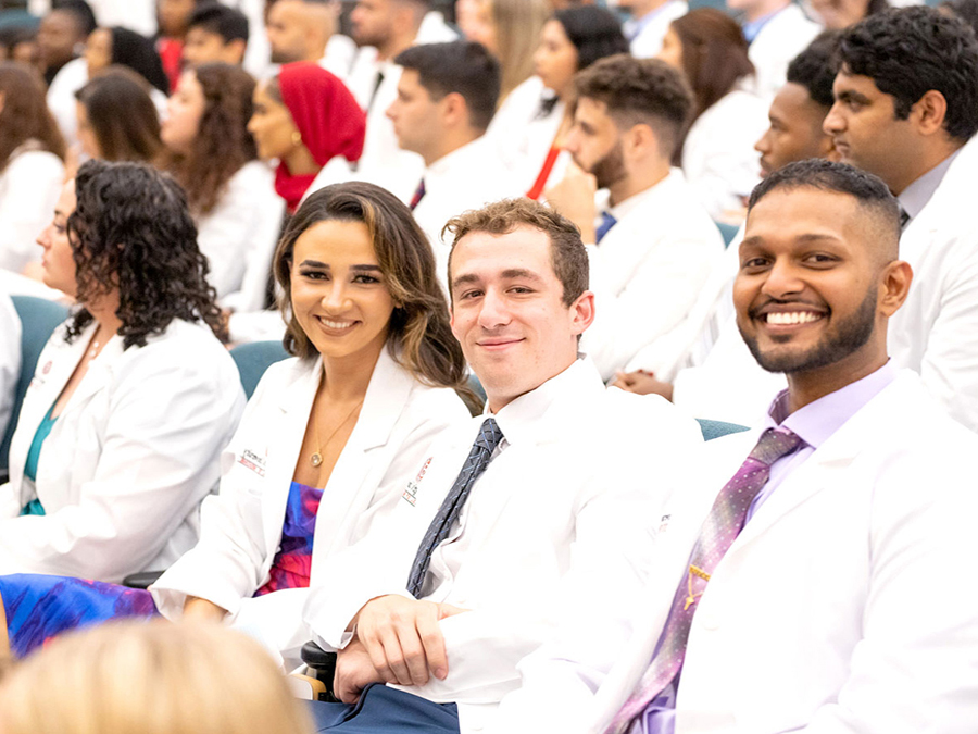 SGU Students wearing their white coats