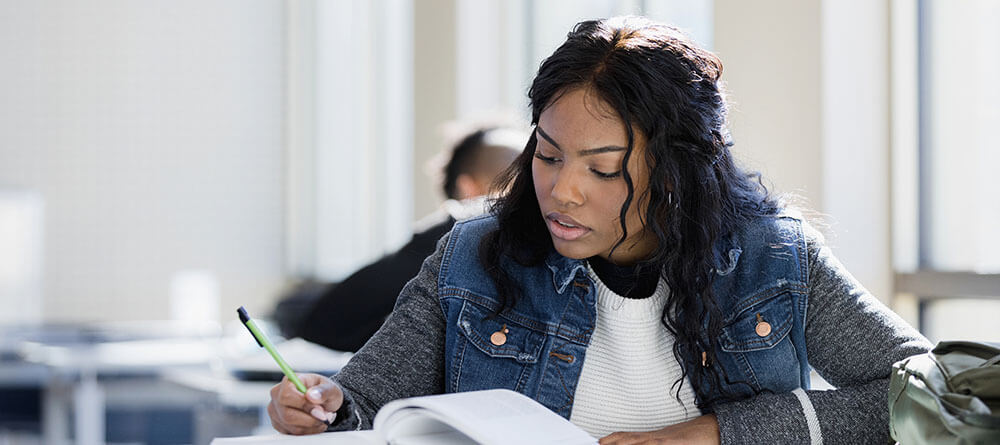 A pre med student studies and prepares for the MCAT exam