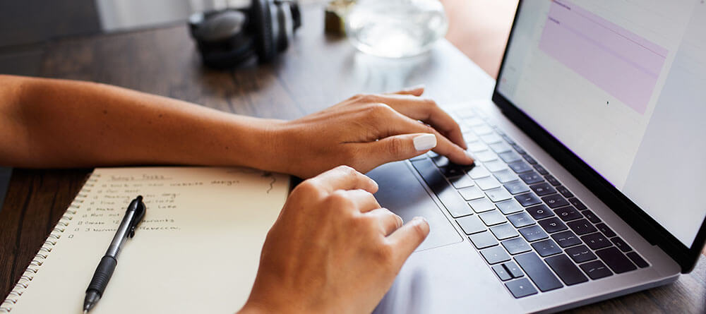 A medical student doing research on a laptop.