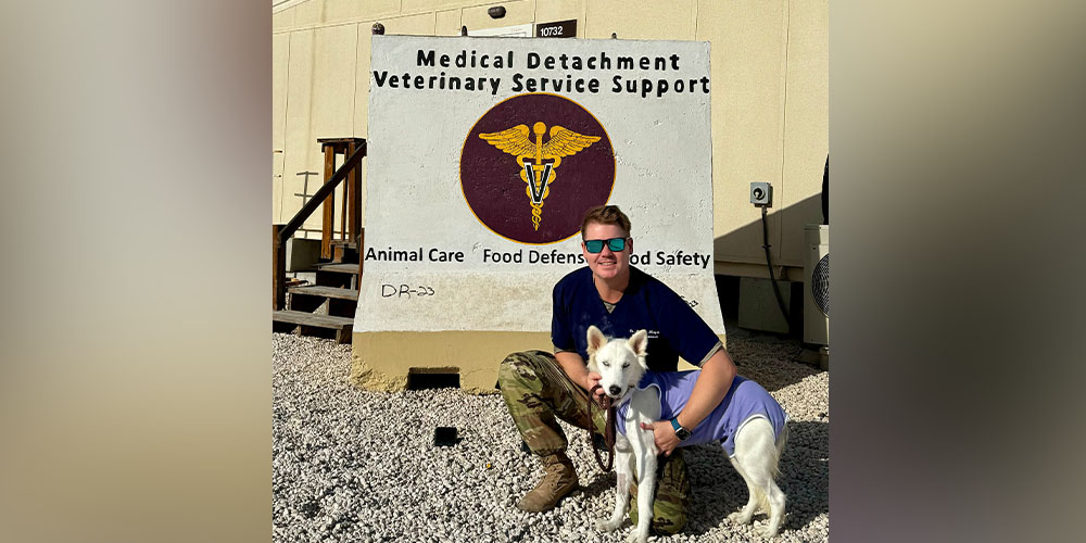 Matthew Morgan, DVM '11, with military dog while deployed