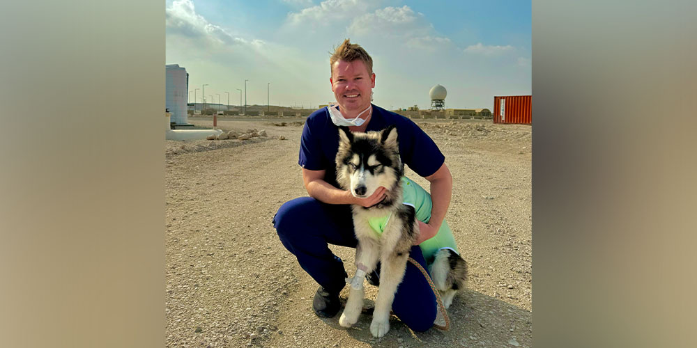 Matthew Morgan, DVM '11, with military dog - husky