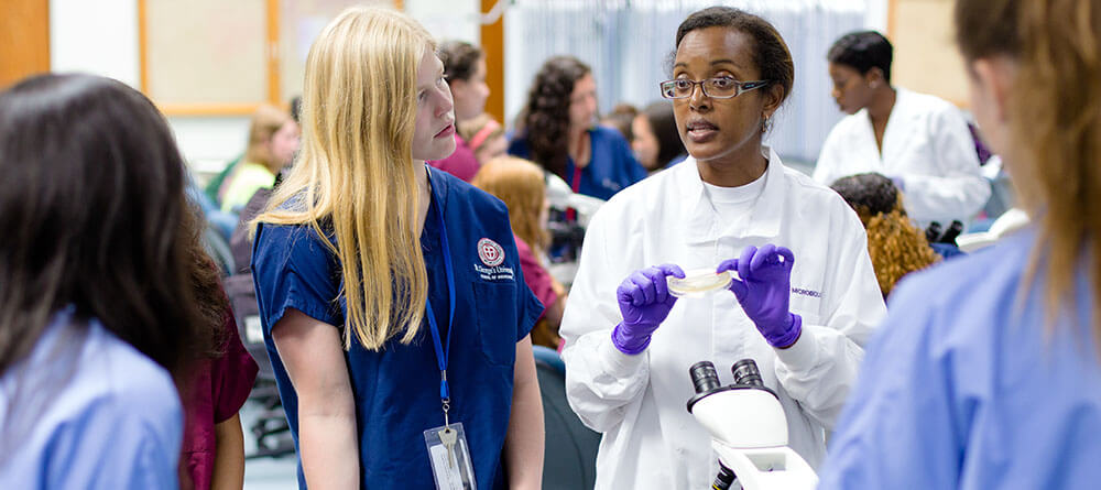An SGU professor instructs students in a laboratory setting