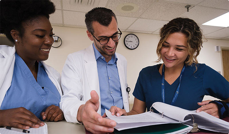 SGU grads reviewing paperwork