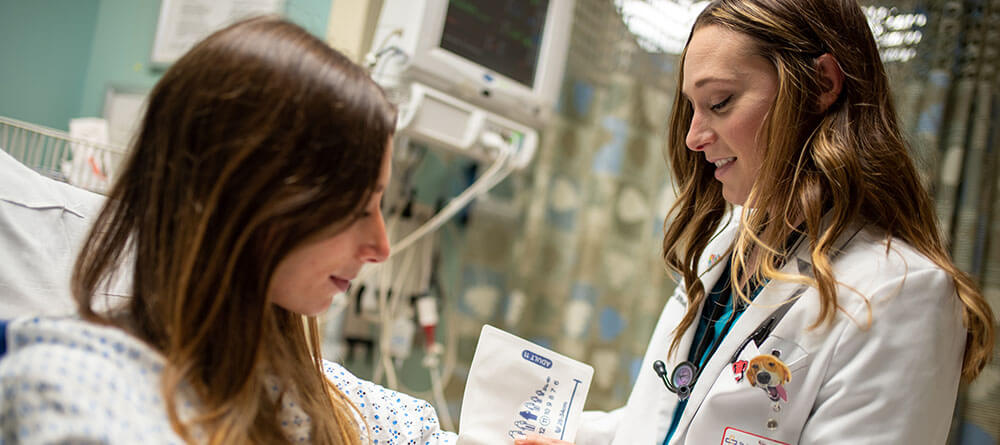 An SGU residency student performs an exam on a patient