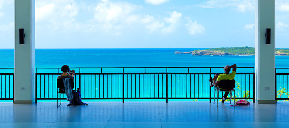 A pair of SGU students study overlooking the Caribbean Sea