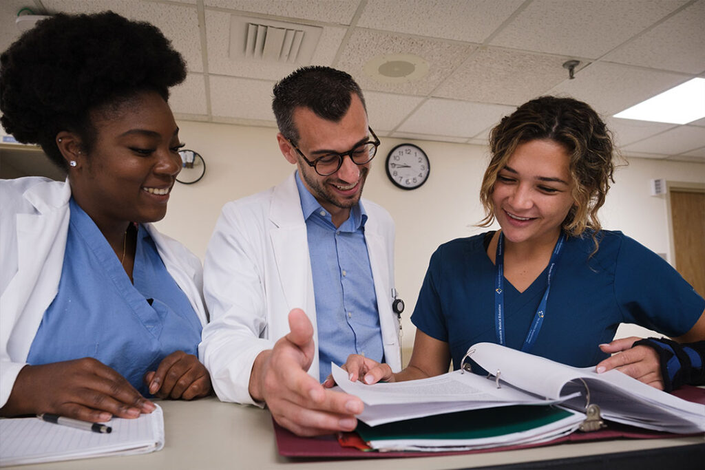 Three clinical students review notes