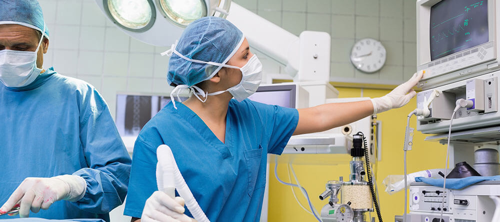 An anesthesiologist monitors a patient during surgery